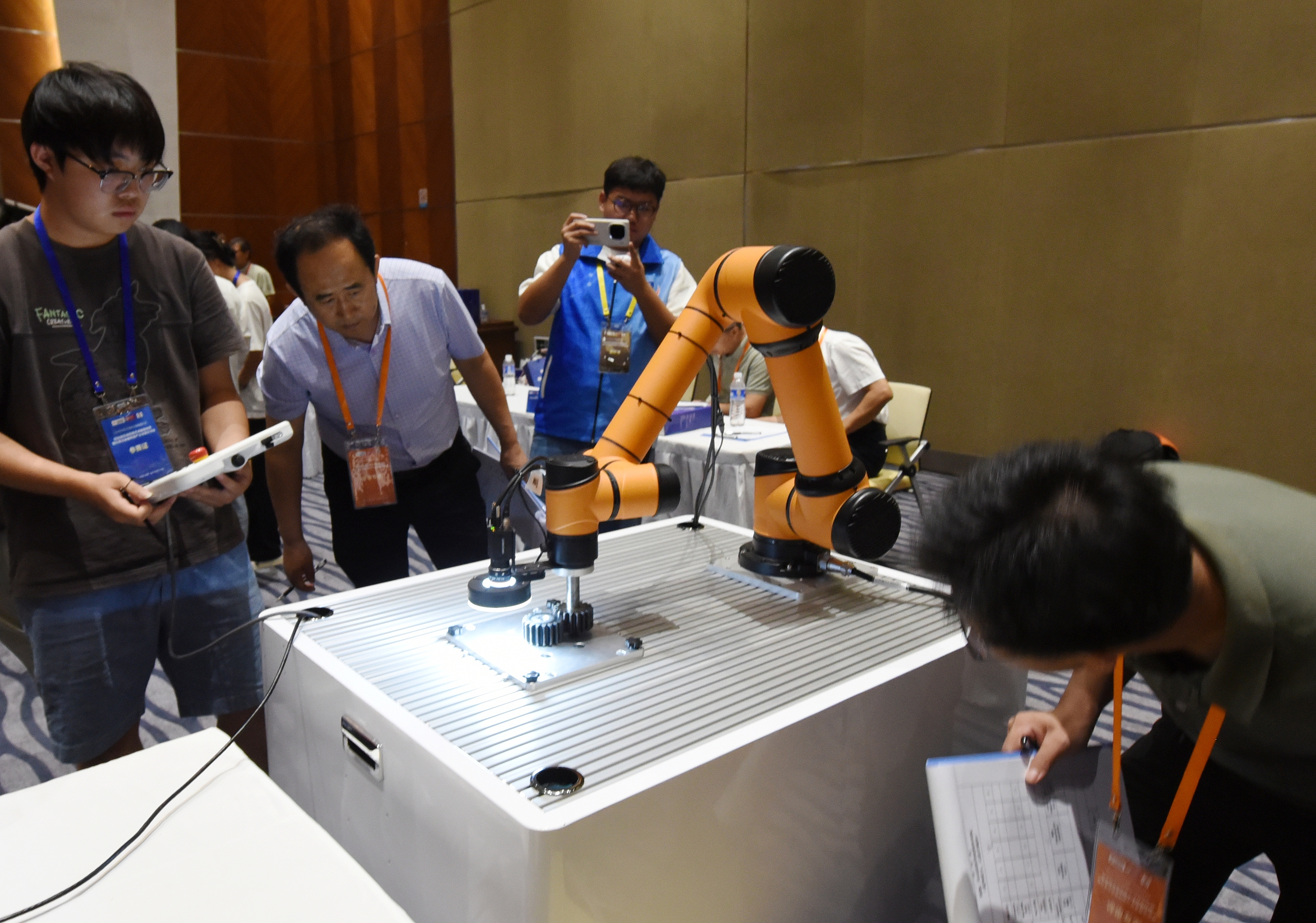 2025年中國大學(xué)生機(jī)械工程創(chuàng)新創(chuàng)意大賽智能精密裝配賽京津冀魯聯(lián)賽現(xiàn)場，評委對參賽選手進(jìn)行實(shí)操調(diào)試評比。